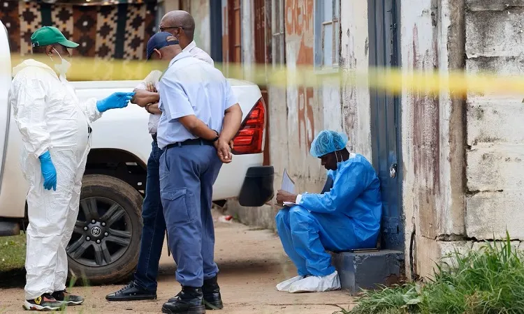 Police forensics personnel work at the scene where several people, including three minors, were shot dead in the Saulsville Hostel in Atteridgeville, Pretoria, South Africa: RUETERS