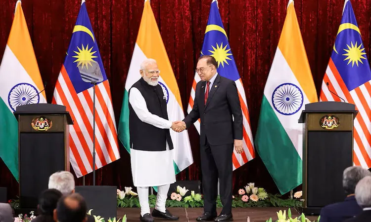 India's Prime Minister Narendra Modi shakes hands with Malaysian Prime Minister Anwar Ibrahim during a press conference on the second day of Modi’s official visit, in Putrajaya, Malaysia.