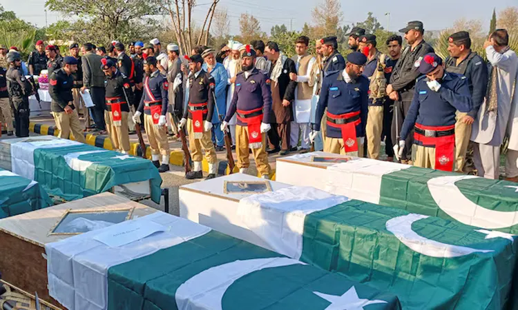 Police officers and residents gather beside Pakistani flag-draped coffins of police officers who were killed following a terrorist attack on a police vehicle, during a funeral in Kohat, in Khyber Pakhtunkhwa province, Pakistan.
