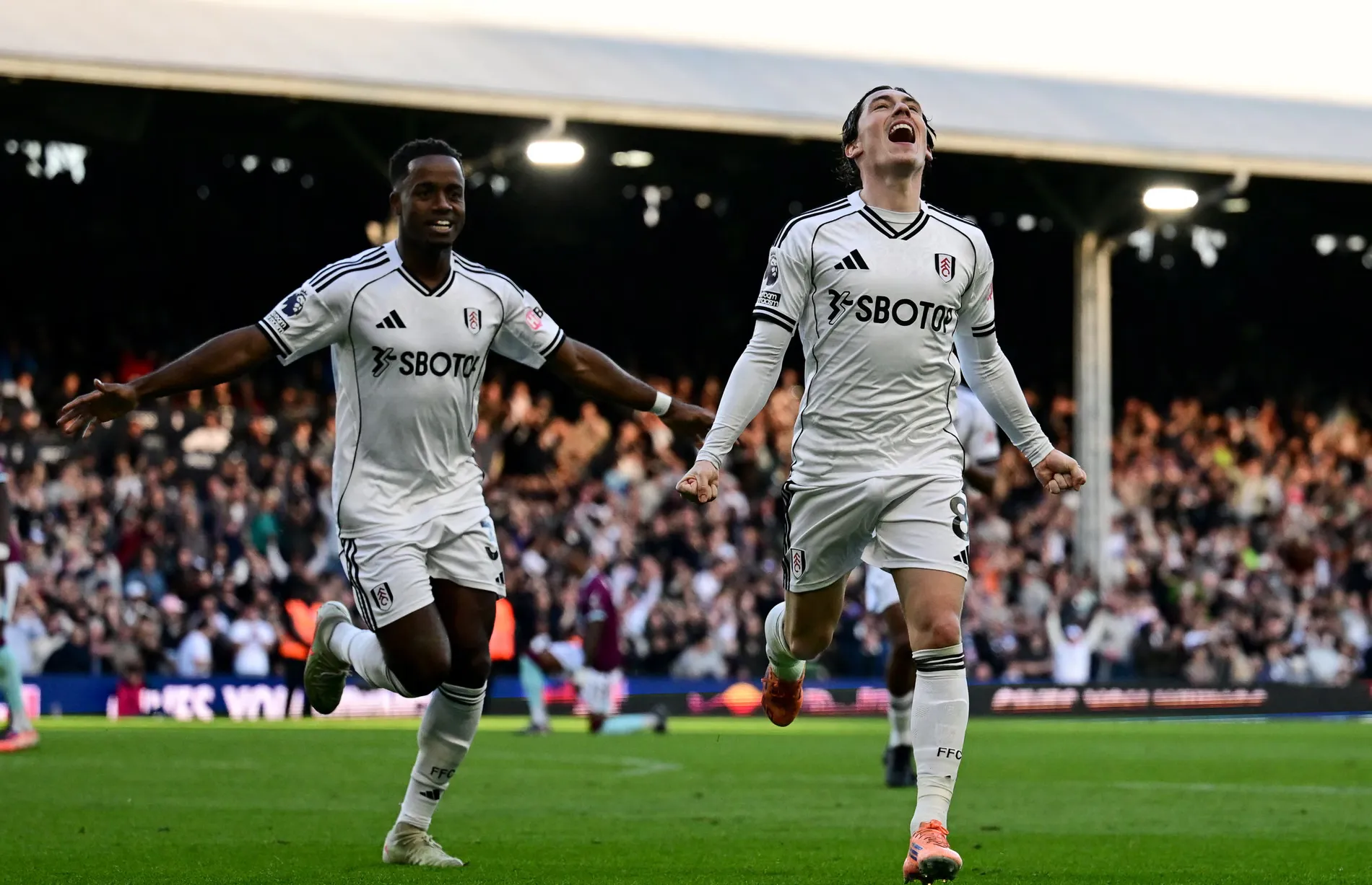 Fulham forward Harry Wilson scores a goal and celebrates with Ryan Sessegnon