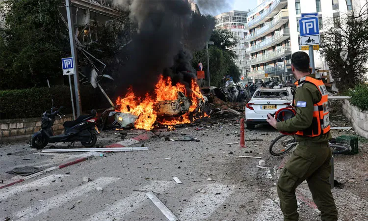 An emergency worker walks at a site following Iranian missile barrages in central Israel.