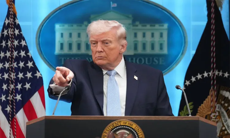 President Donald Trump speaks with reporters