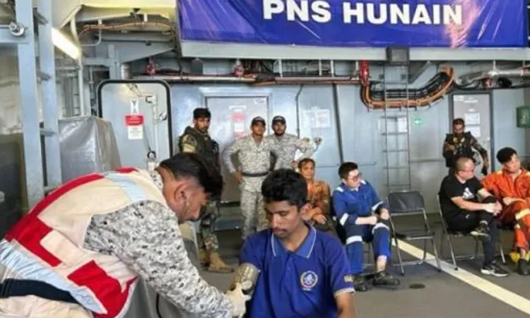 Pakistan Navy personnel attend to crew of a merchant vessel aboard PNS HUNAIN after their rescue in the North Arabian Sea
