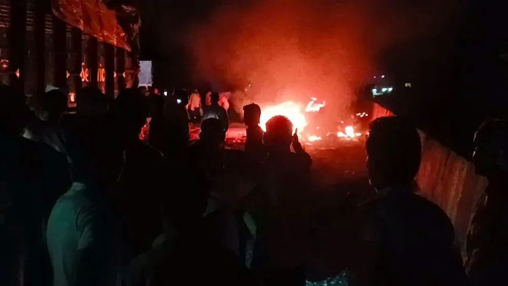 A car got stuck between two trucks in the collision.