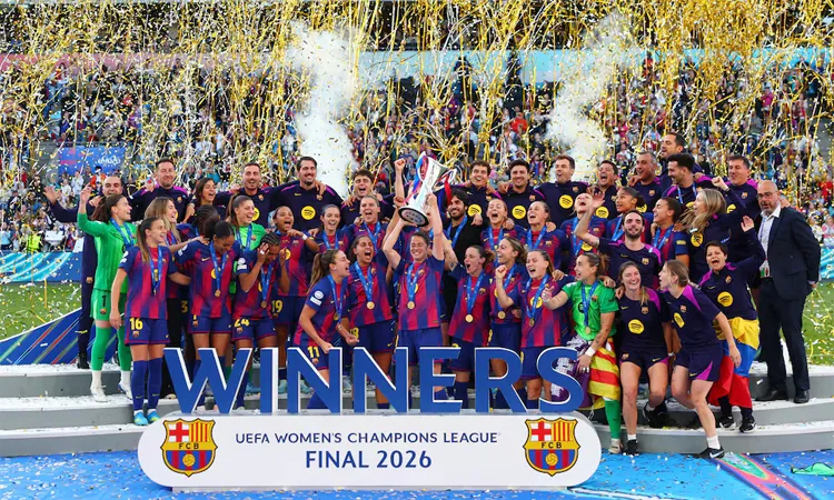 FC Barcelona's Marta Torrejon lifts the trophy as she celebrates winning the UEFA Women's Champions League with her teammates.