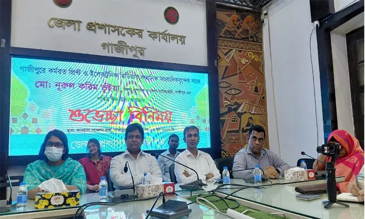 DC Md. Nurul Karim Bhuiyan exchanges Eid greetings with journalists.