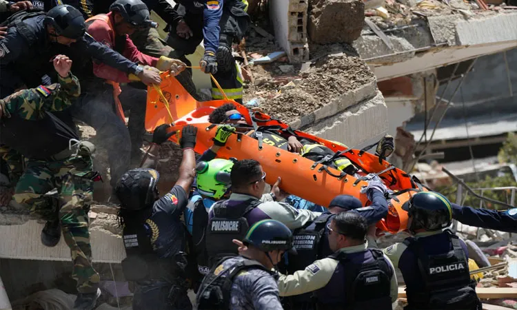 Rescue workers pulls survivors from the rubble three days after earthquakes struck La Guaira, Venezuela.