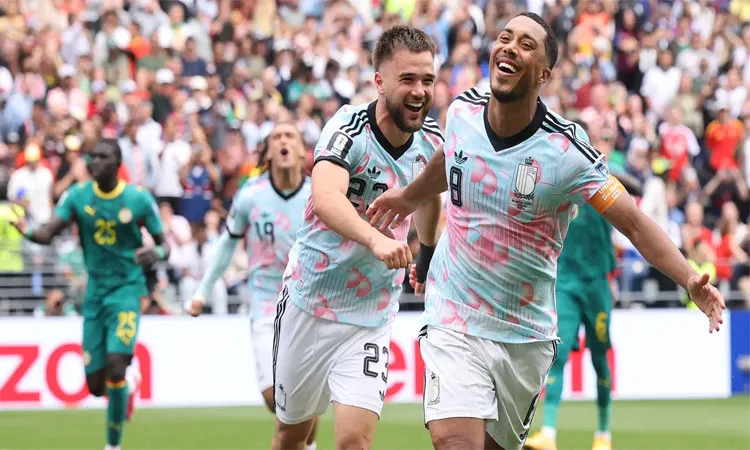 Belgium's Youri Tielemans celebrates scoring their third goal with Nicolas Raskin.