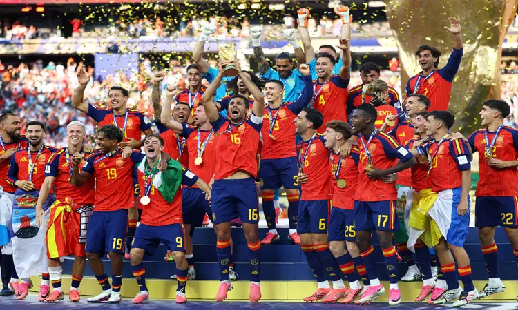 Spain's Rodri lifts the World Cup trophy alongside teammates as they celebrate winning the World Cup.