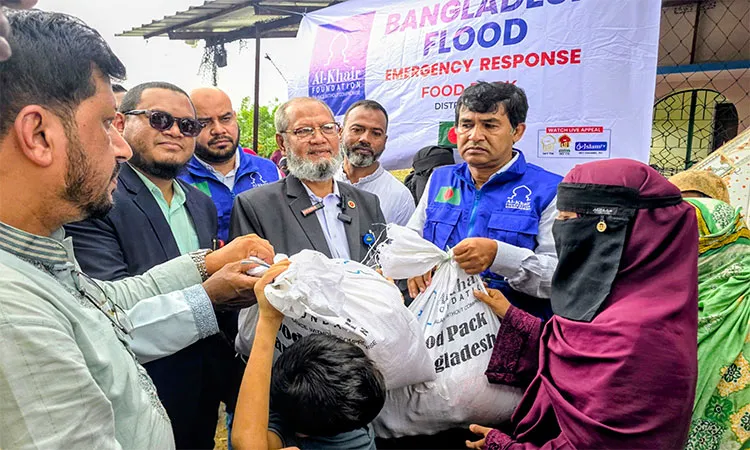 NGO Bureau Director General Dr. Zakaria distributing relief among the flood victims.