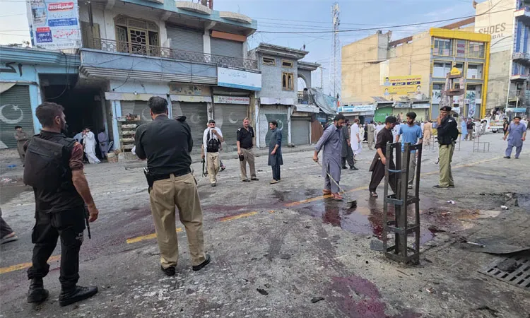 Police officers examine the site following a suicide bombing in Kabal, a town in the Swat Valley in Pakistan’s Khyber Pakhtunkhwa province.