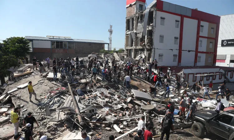 Residents and rescue workers search through the rubble of a collapsed building after an earthquake struck Cali, Colombia.
