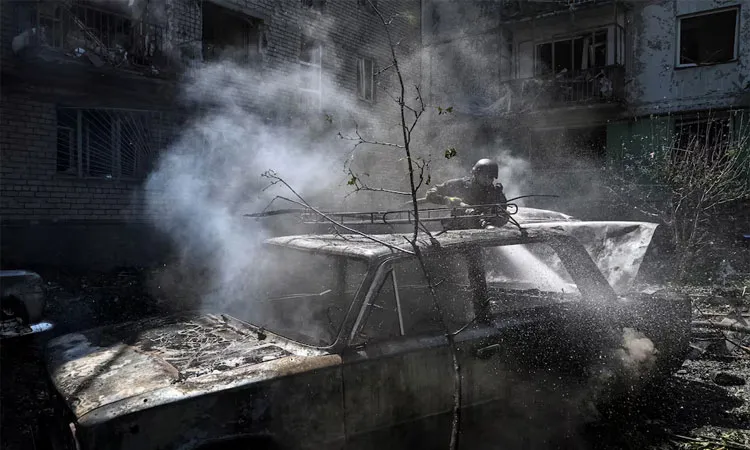 A firefighter works at a site of an apartment building damaged during a Russian air strike amid Russia's attack on Ukraine.
