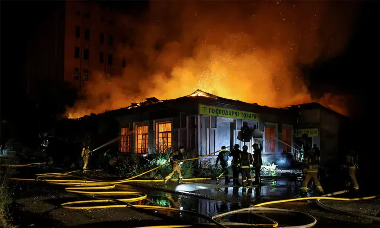 Firefighters work at a site hit by a Russian missile strike amid Russia's attack on Ukraine in Kyiv.