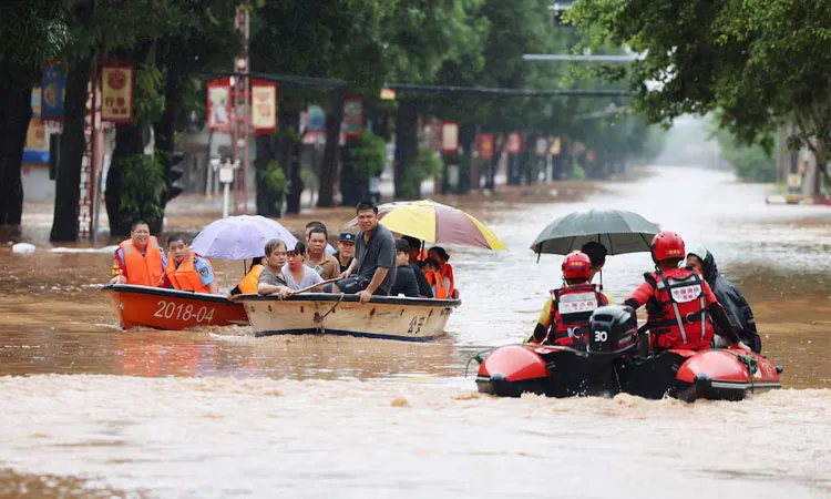 Rescue workers evacuate flood-affected residents by boat after heavy rainfall brought by typhoon Narra caused flooding in China.