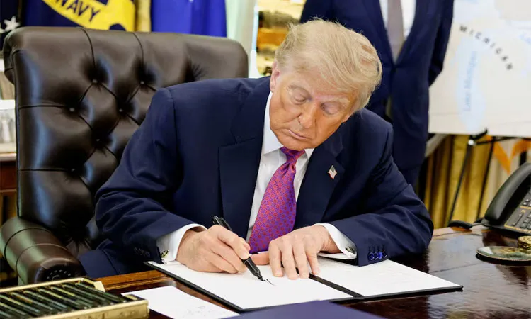 U.S. President Donald Trump signs an executive order to rename Lake Ontario as Lake America at the Oval Office of the White House.