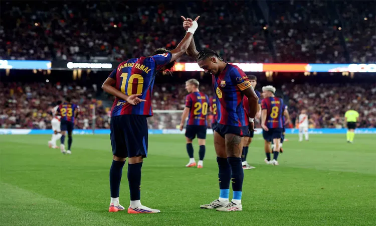 Barcelona's Lamine Yamal celebrates scoring their second goal with Raphinha