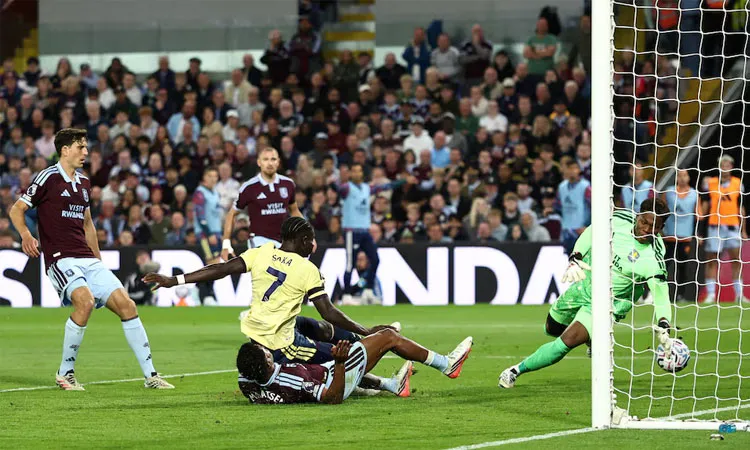 Arsenal's Bukayo Saka scores their first goal past Aston Villa's Zion Suzuki