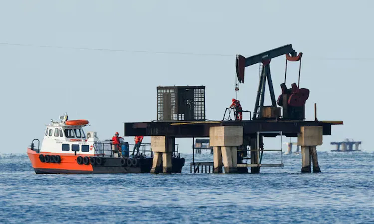 Venezuelan state oil company PDVSA labour at an operating pumpjack in Lake Maracaibo in Cabimas, Venezuela.