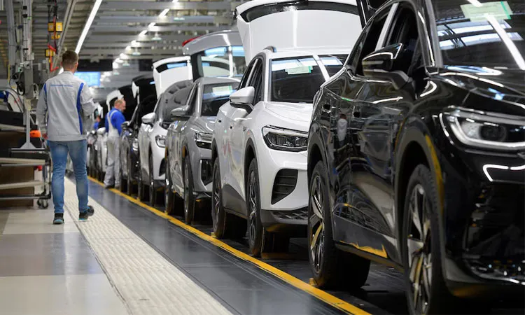 Technicians work at the production line for electric car models of the Volkswagen Group in Zwickau, Germany.