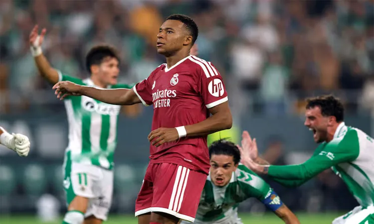Kylian Mbappe looks dejected after his penalty is saved by Real Betis' Alvaro Valles.