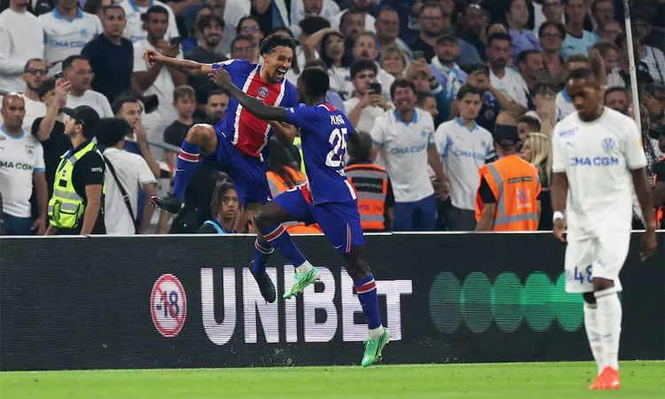 Marquinhos celebrates scoring their second goal with Nuno Mendes.