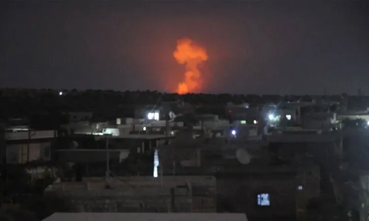 Blasts heard in town of Al-Eis, with local sources saying they occurred at a Defense Ministry ammunition depot.