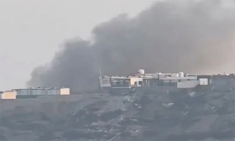 Smoke billows from the presidential palace following an attack by the Houthis according to government officials in Aden
