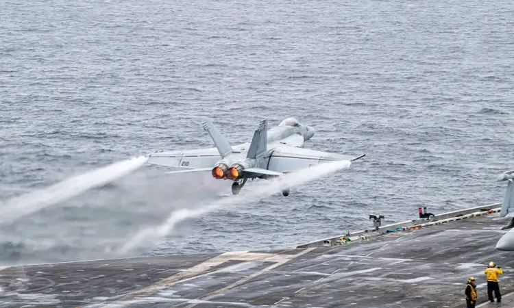 A US fighter jet takes off from the USS Theodore Roosevelt aircraft carrier