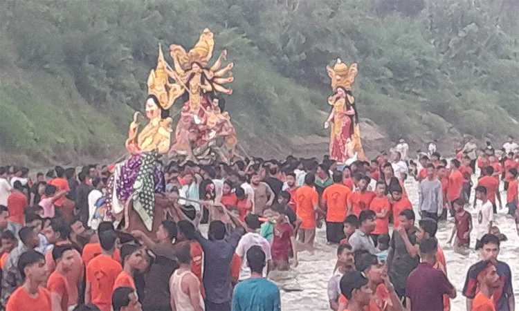 The procession moved through major town roads before gathering at the riverbank.