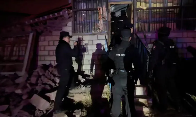 Emergency services personnel at a damaged building following an earthquake.
